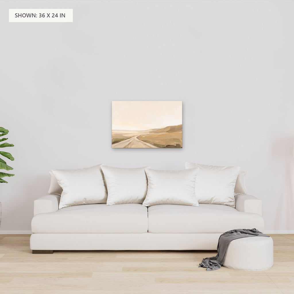 Rolling Fields Under a Pale Sky canvas, 36 x 24 in, above a sofa; room setting for illustration